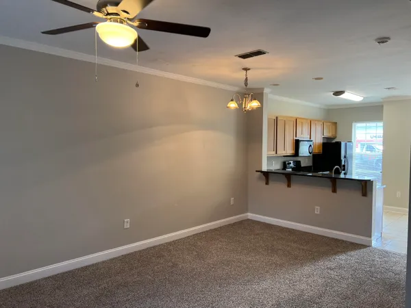 a view of a room with a ceiling fan and a window