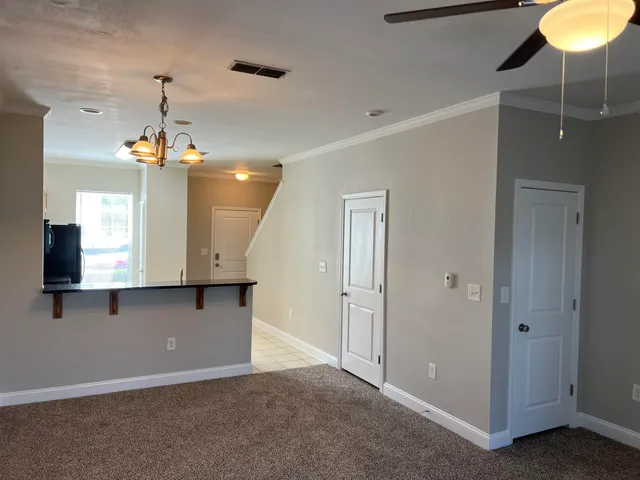 a view of a hallway with a chandelier