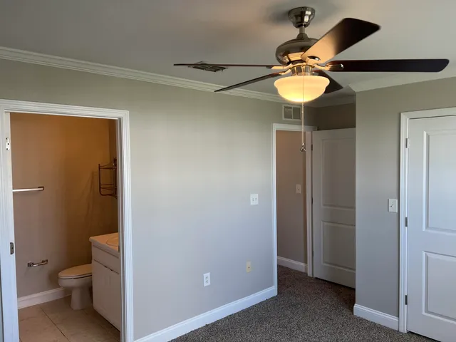 a bathroom with a light fixture and a toilet