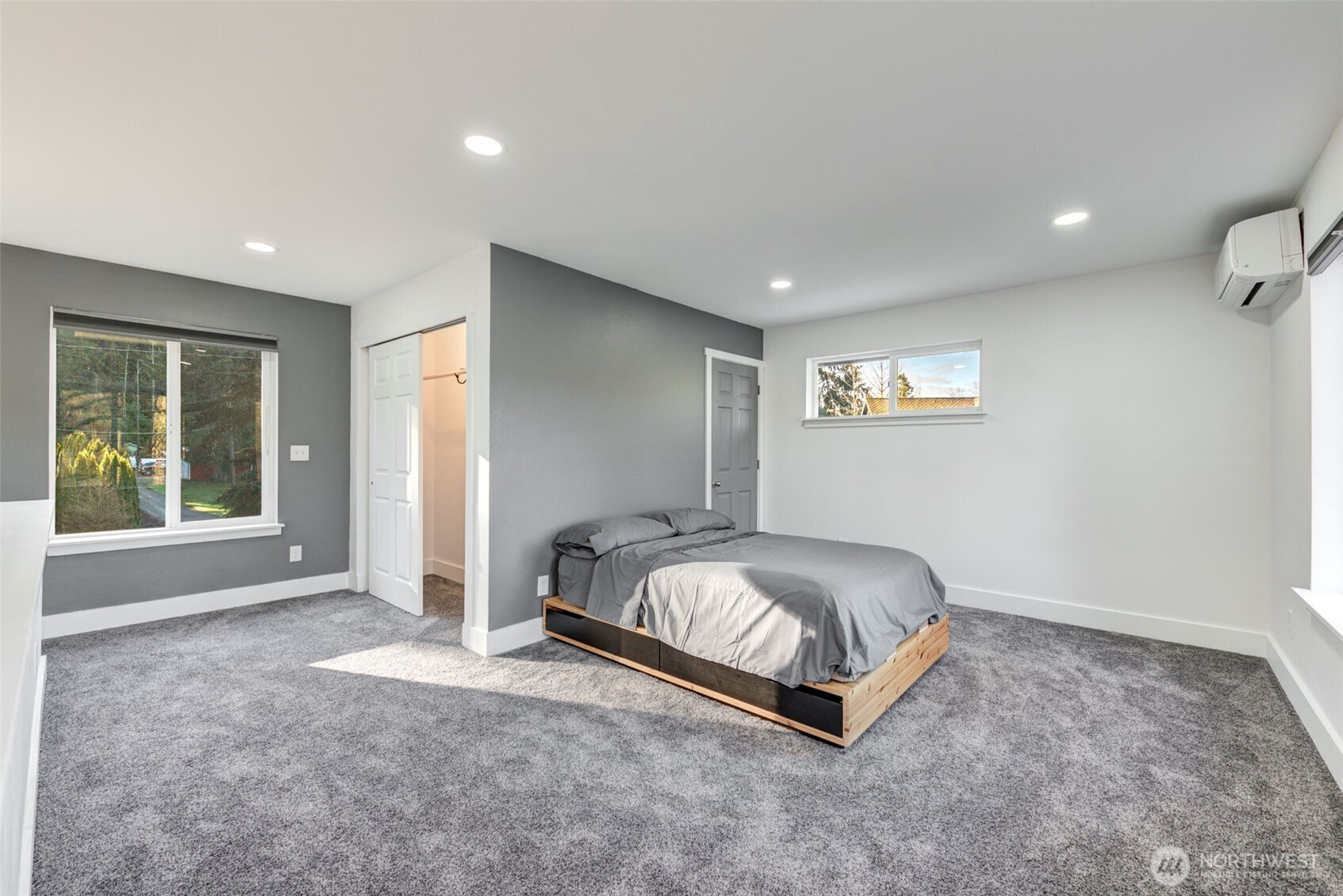 26015 166th Street Southeast, Unit B Monroe, WA 98272 - Photo 16 of 28 a spacious bedroom with a bed and a window