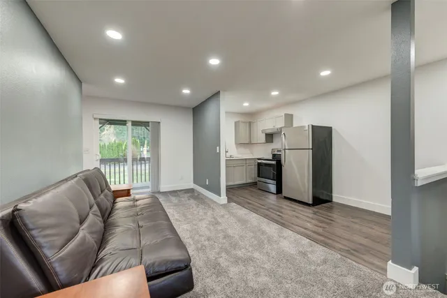 a living room with furniture and kitchen view