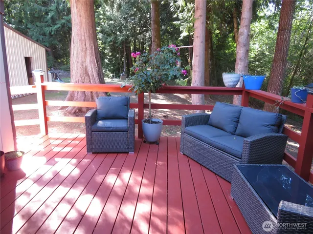 a front view of a house with garden and sitting area