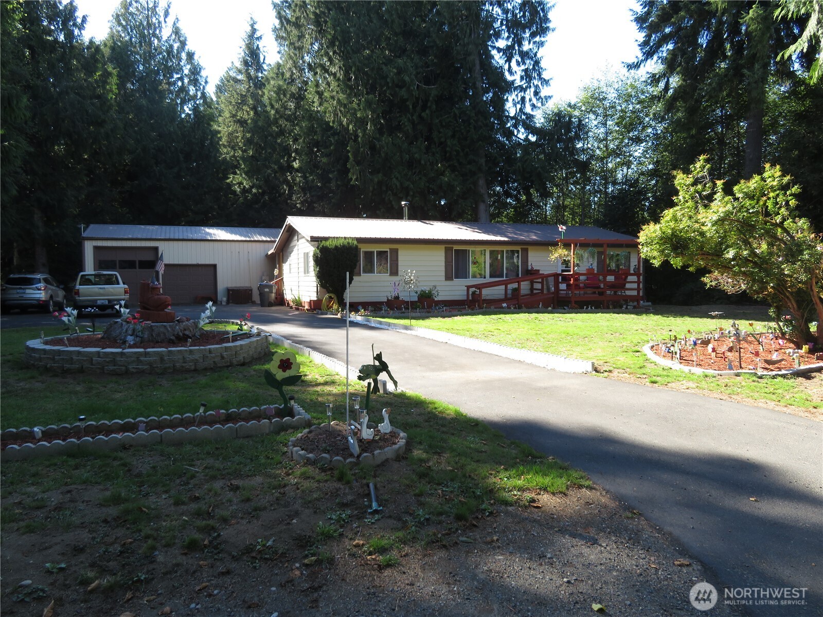 222 Delezenne Road Elma, WA 98541 - Photo 31 of 31 a front view of a house with garden and sitting area