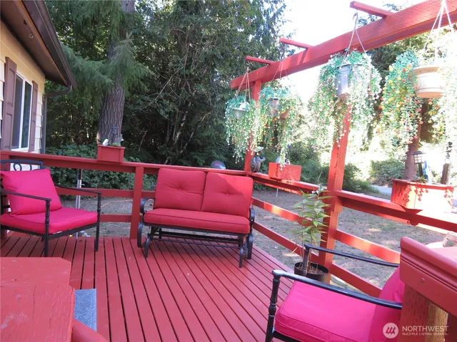 a outdoor sitting area with furniture and wooden floor