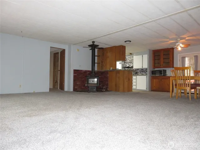 a view of kitchen with refrigerator and window