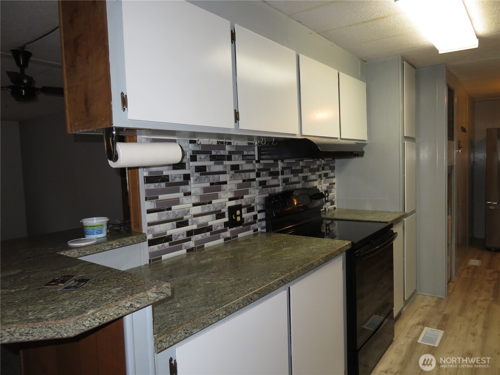 222 Delezenne Road Elma, WA 98541 - Photo 10 of 31 a kitchen with granite countertop a sink and a stove