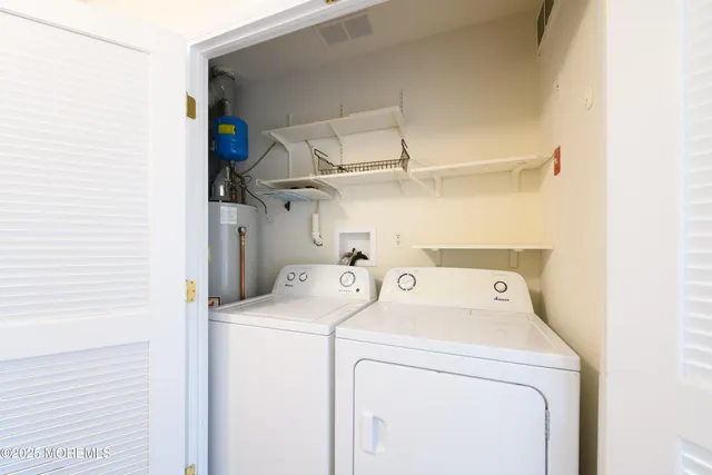 a view of storage and utility room with washer and dryer