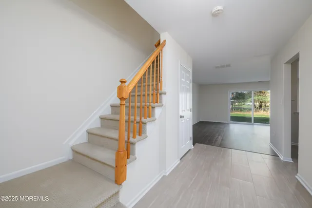a view of entryway and hall with wooden floor