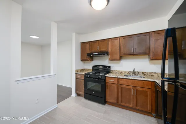 a kitchen with a stove top oven sink and cabinets