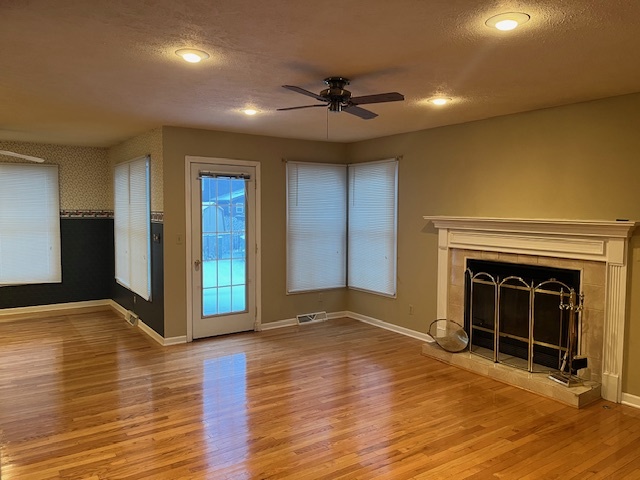 1210 Sunset Terrace Rochelle, IL 61068 - Photo 6 of 38 a view of an empty room with wooden floor fireplace and a window