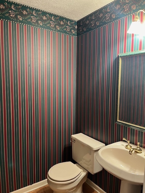 1210 Sunset Terrace Rochelle, IL 61068 - Photo 8 of 38 a bathroom with a sink a toilet and shower curtain