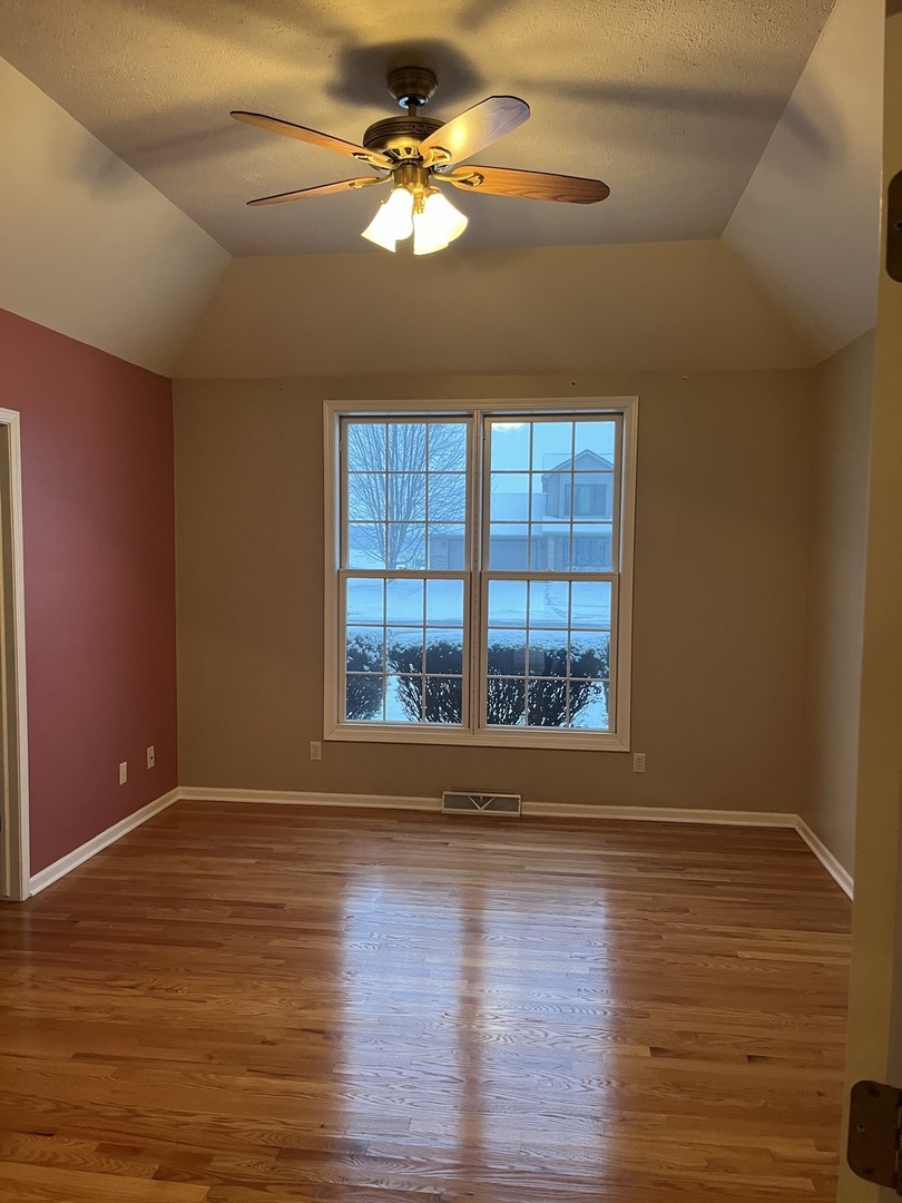 1210 Sunset Terrace Rochelle, IL 61068 - Photo 9 of 38 a view of an empty room with wooden floor and a window