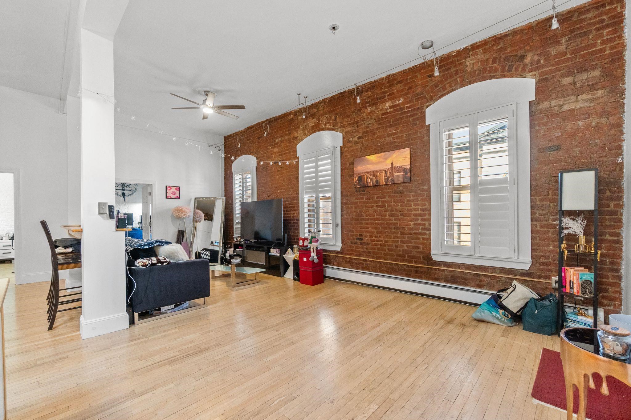 76 Jackson Street, Unit 4R Hoboken, NJ 07030 - Photo 1 of 17 a living room with furniture window and wooden floor