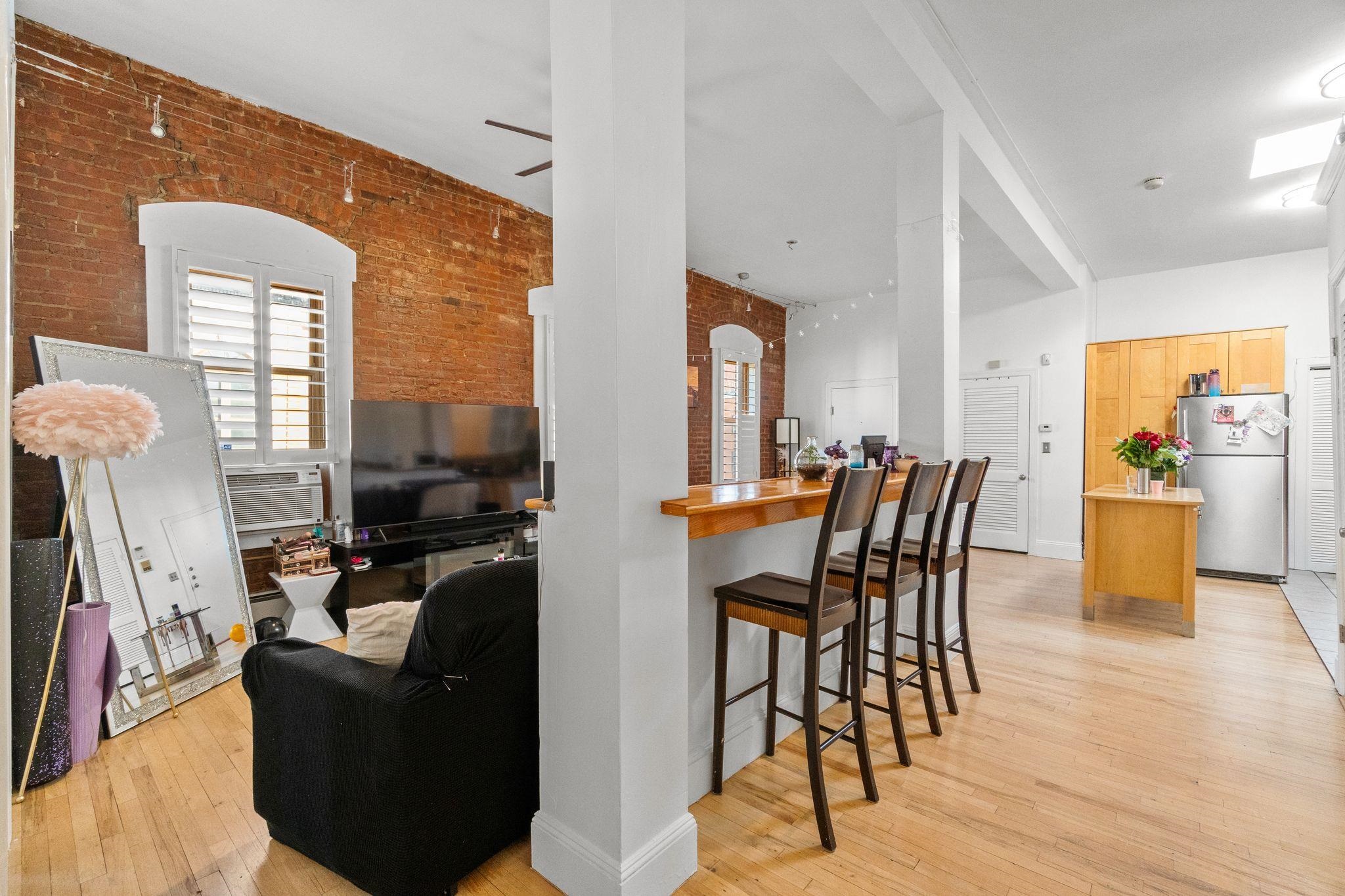 76 Jackson Street, Unit 4R Hoboken, NJ 07030 - Photo 11 of 17 a dining room with furniture and wooden floor