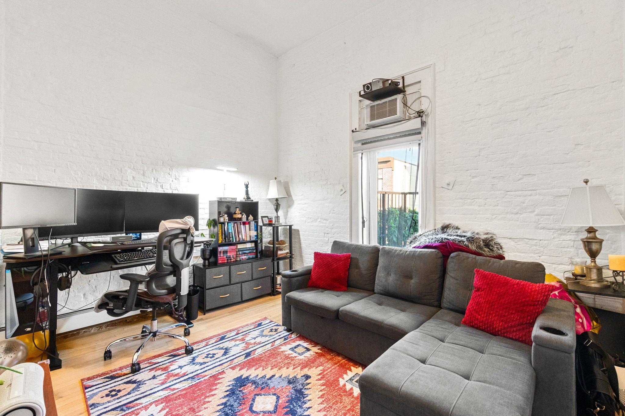 76 Jackson Street, Unit 4R Hoboken, NJ 07030 - Photo 13 of 17 a living room with furniture and a window