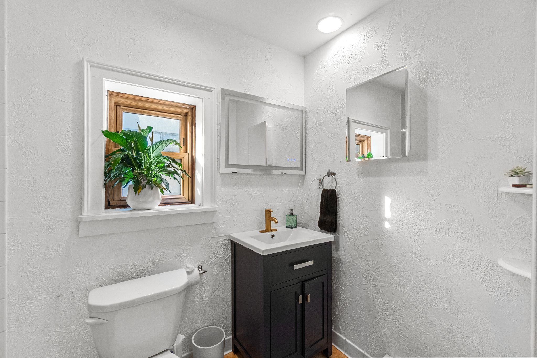 76 Jackson Street, Unit 4R Hoboken, NJ 07030 - Photo 14 of 17 a bathroom with a toilet sink and mirror