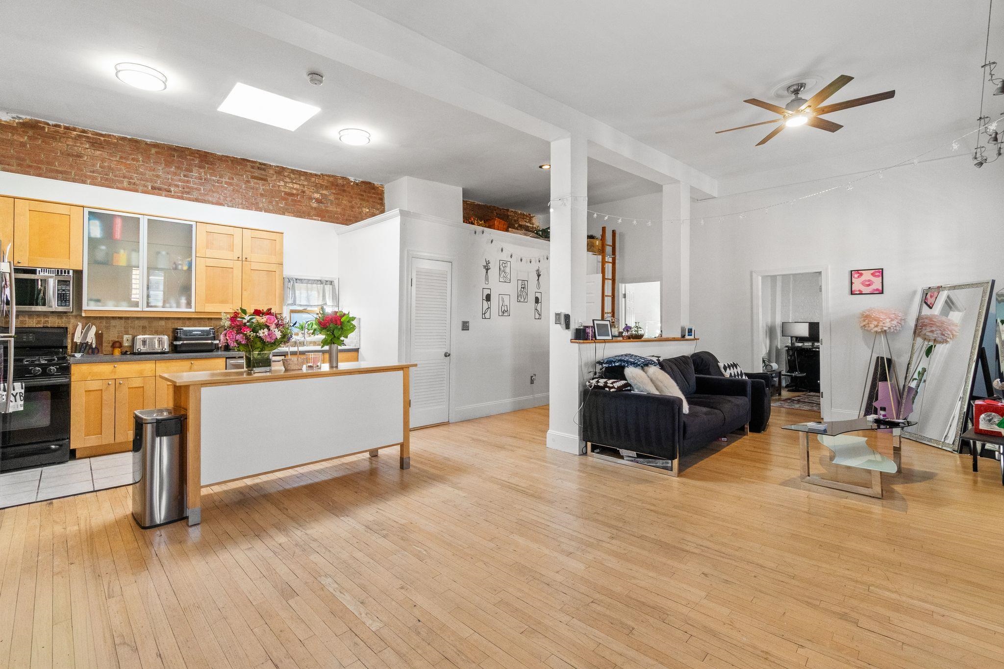 76 Jackson Street, Unit 4R Hoboken, NJ 07030 - Photo 2 of 17 a living room with furniture and kitchen view
