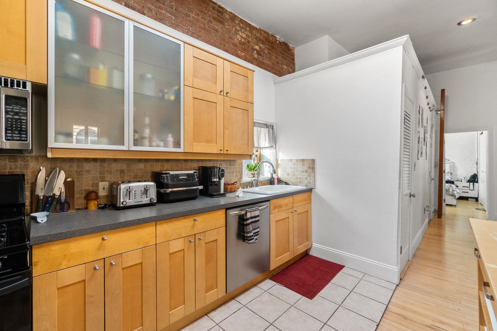 76 Jackson Street, Unit 4R Hoboken, NJ 07030 - Photo 7 of 17 a kitchen with stainless steel appliances granite countertop a sink and cabinets
