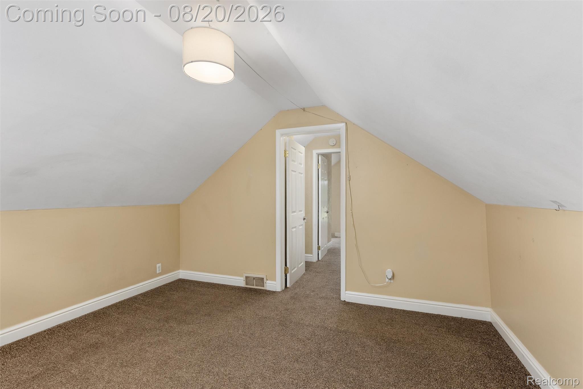 4465 South Center Road Burton, MI 48519 - Photo 22 of 24 Room featuring sloped ceilings, neutral-toned walls, and brown carpet flooring