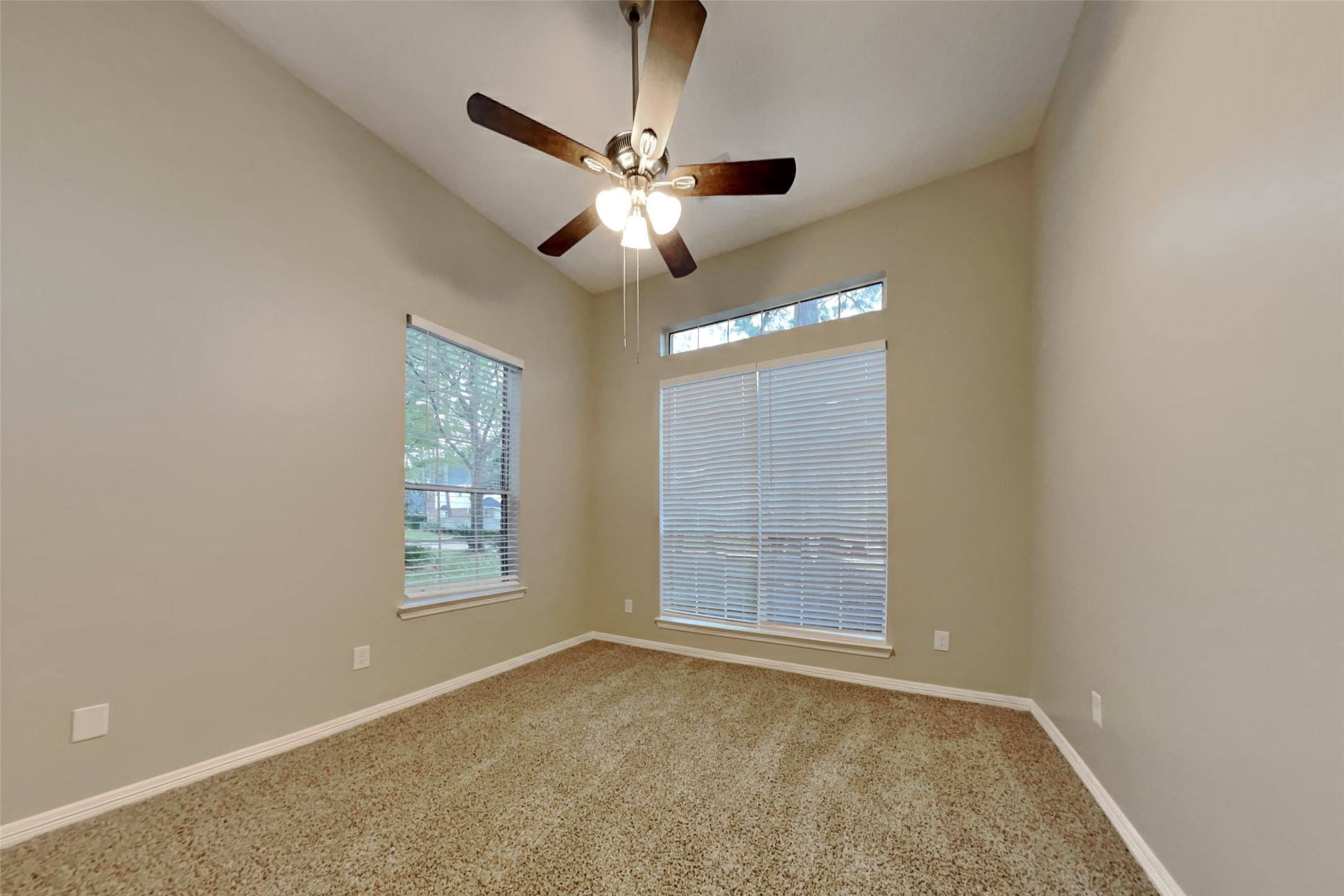 18730 Dempsey Oaks Drive Humble, TX 77346 - Photo 11 of 18 an empty room with windows and fan