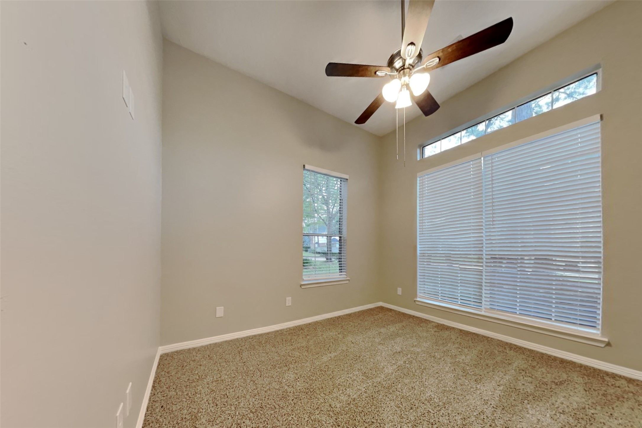 18730 Dempsey Oaks Drive Humble, TX 77346 - Photo 12 of 18 an empty room with windows and fan