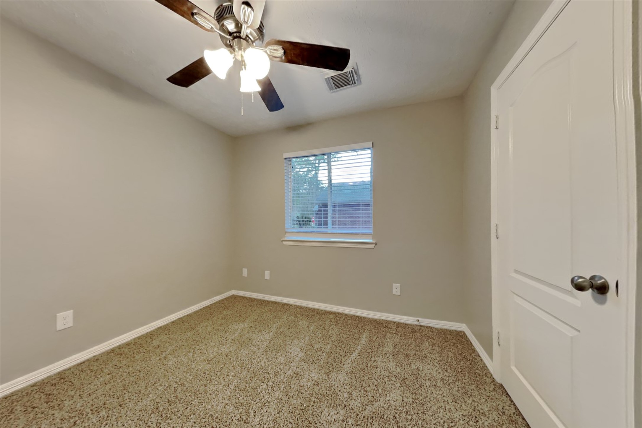 18730 Dempsey Oaks Drive Humble, TX 77346 - Photo 13 of 18 an empty room with windows and fan