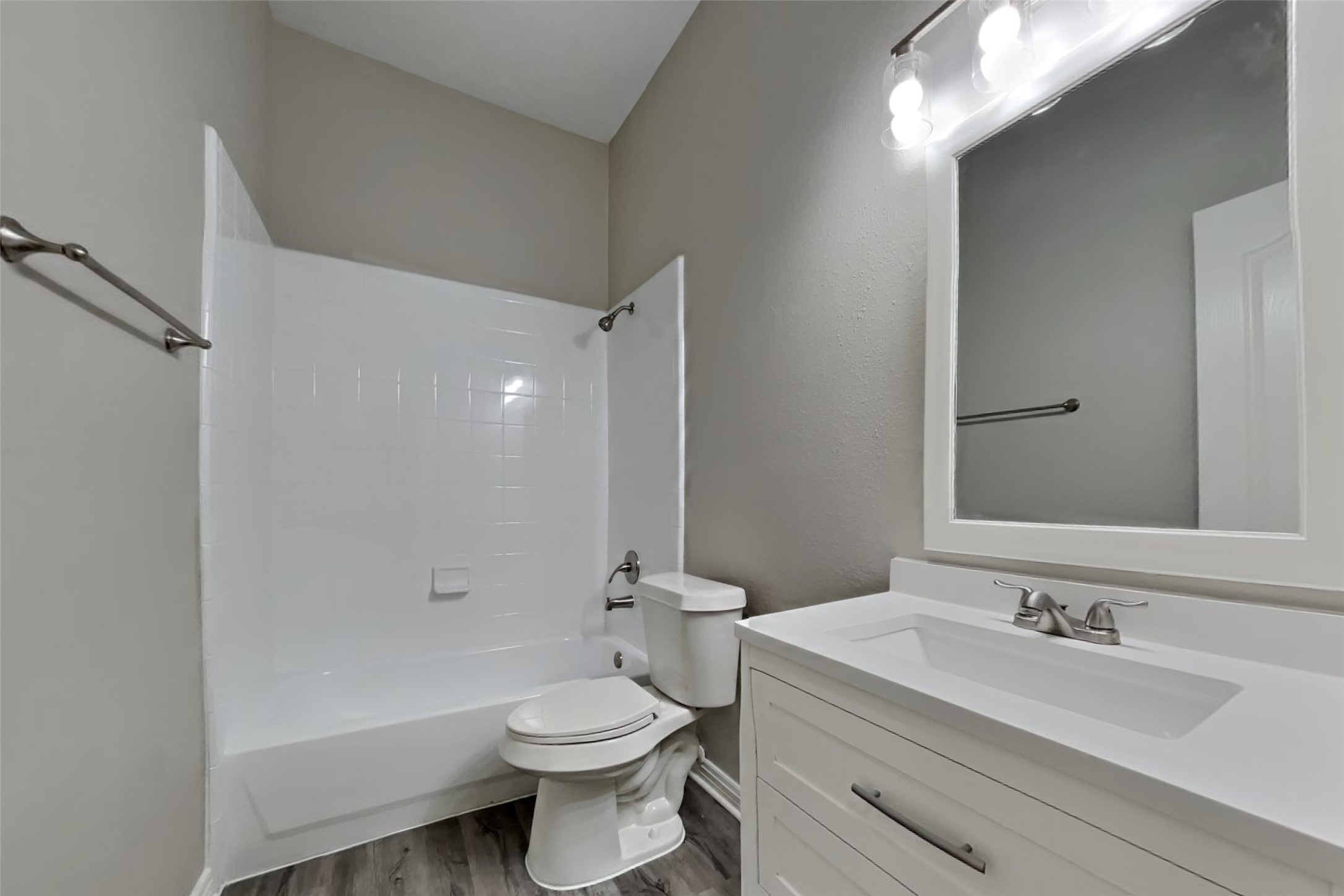 18730 Dempsey Oaks Drive Humble, TX 77346 - Photo 15 of 18 a bathroom with a toilet a sink a mirror and a bathtub