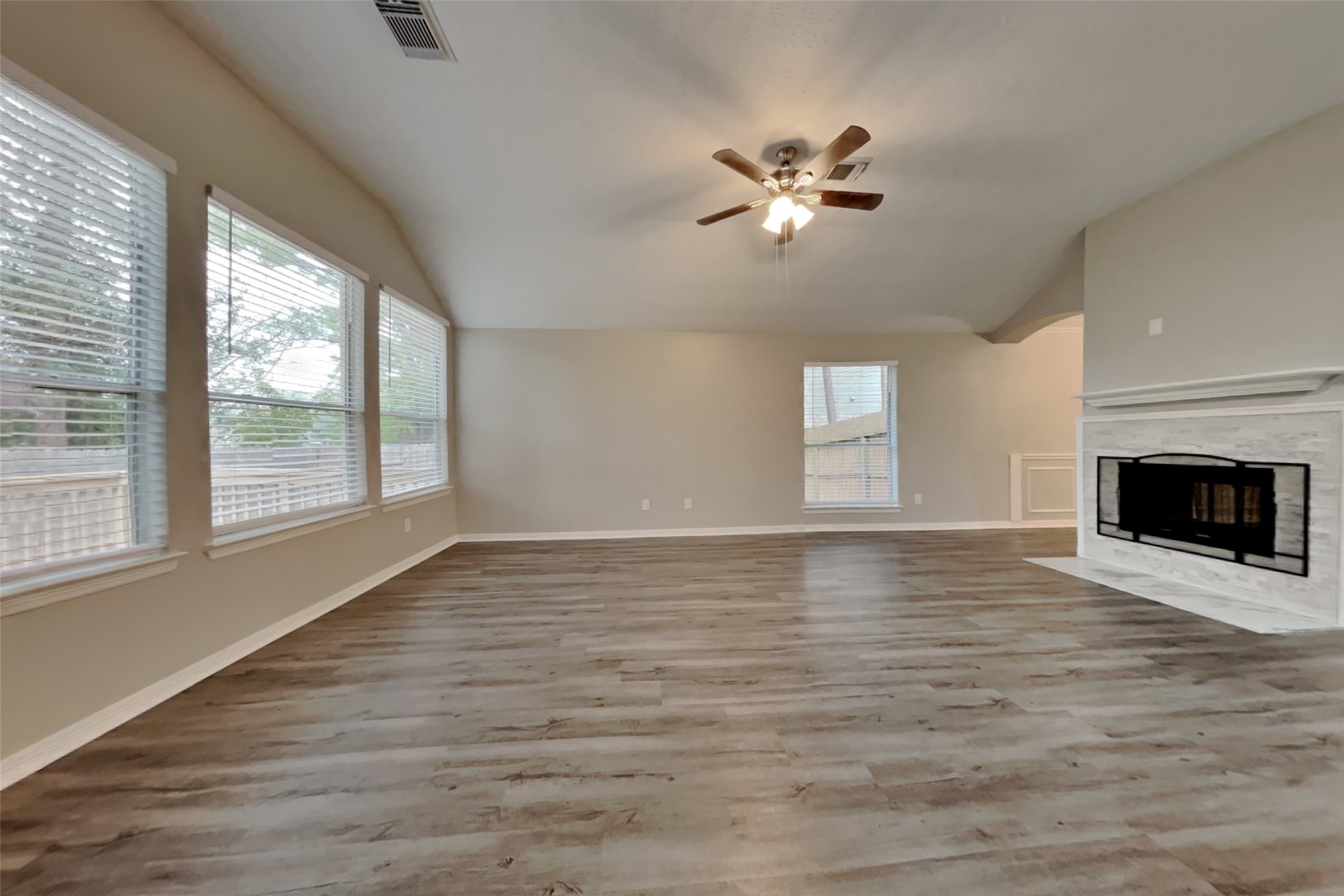 18730 Dempsey Oaks Drive Humble, TX 77346 - Photo 2 of 18 a view of an empty room with a window and wooden floor