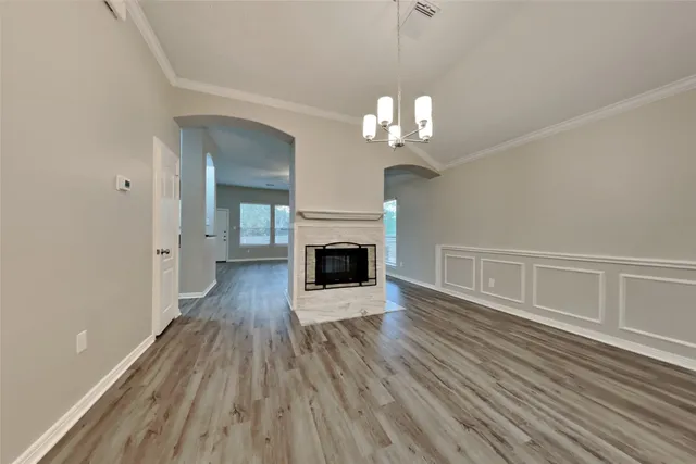 wooden floor in an empty room with a fireplace