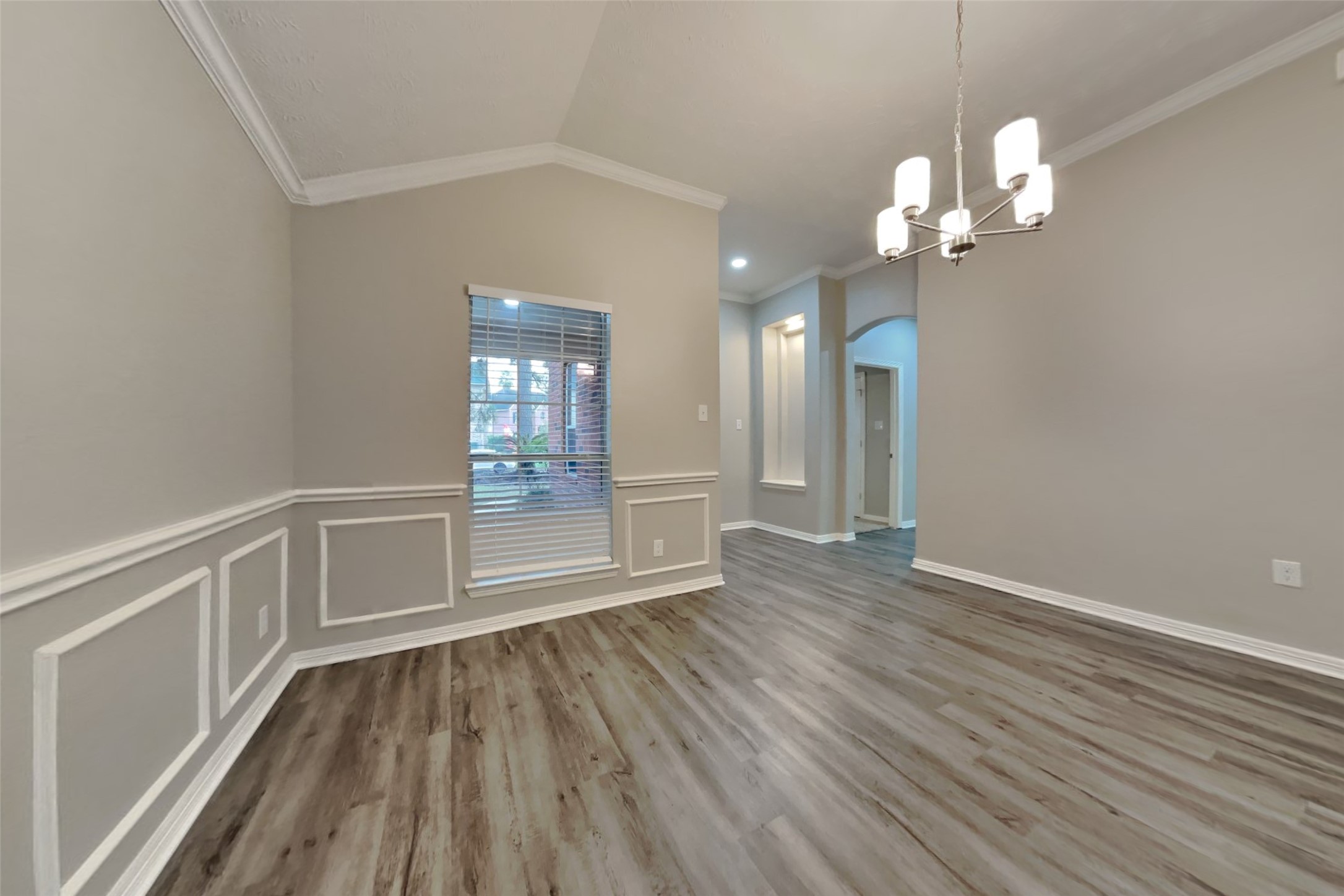 18730 Dempsey Oaks Drive Humble, TX 77346 - Photo 7 of 18 a view of an empty room with wooden floor and a window