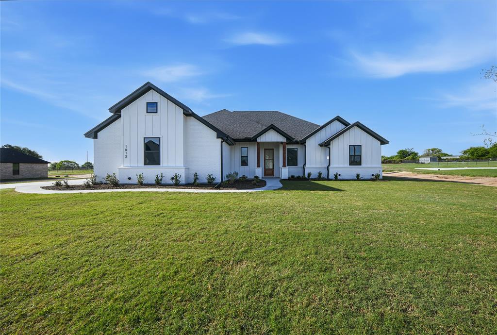1012 Katie Court Azle, TX 76020 - Photo 1 of 1 a front view of a house with a garden and yard
