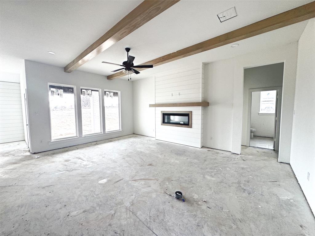 1012 Katie Court Azle, TX 76020 - Photo 4 of 7 Unfurnished living room featuring a fireplace, ceiling fan, and beam ceiling