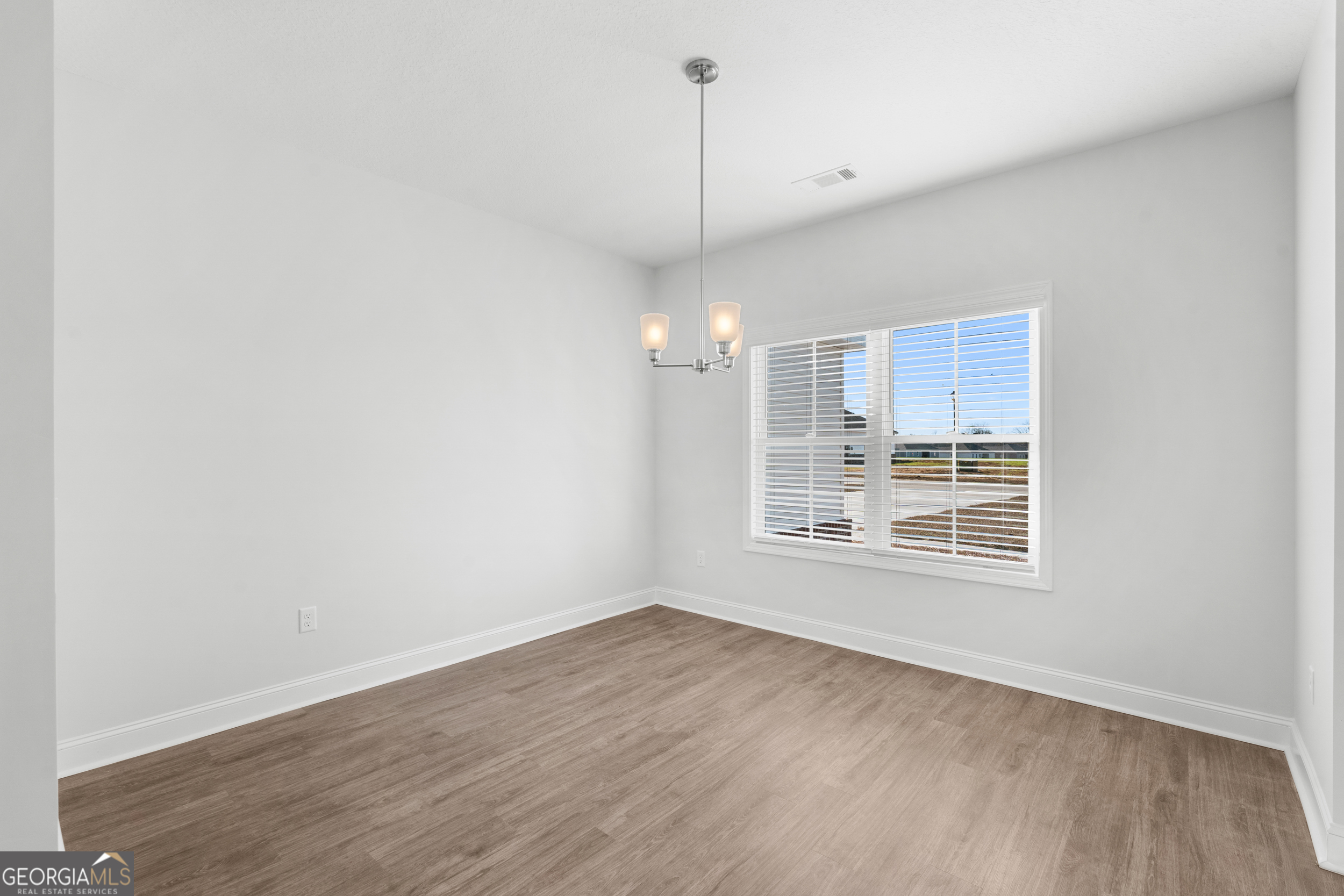 209 Hopecrest Road Statesboro, GA 30458 - Photo 11 of 27 a view of a kitchen with wooden floor and windows