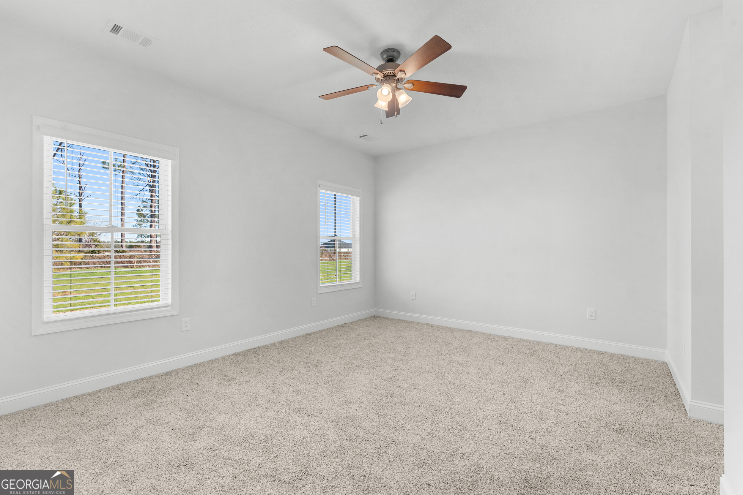 209 Hopecrest Road Statesboro, GA 30458 - Photo 13 of 27 an empty room with a window and a fan