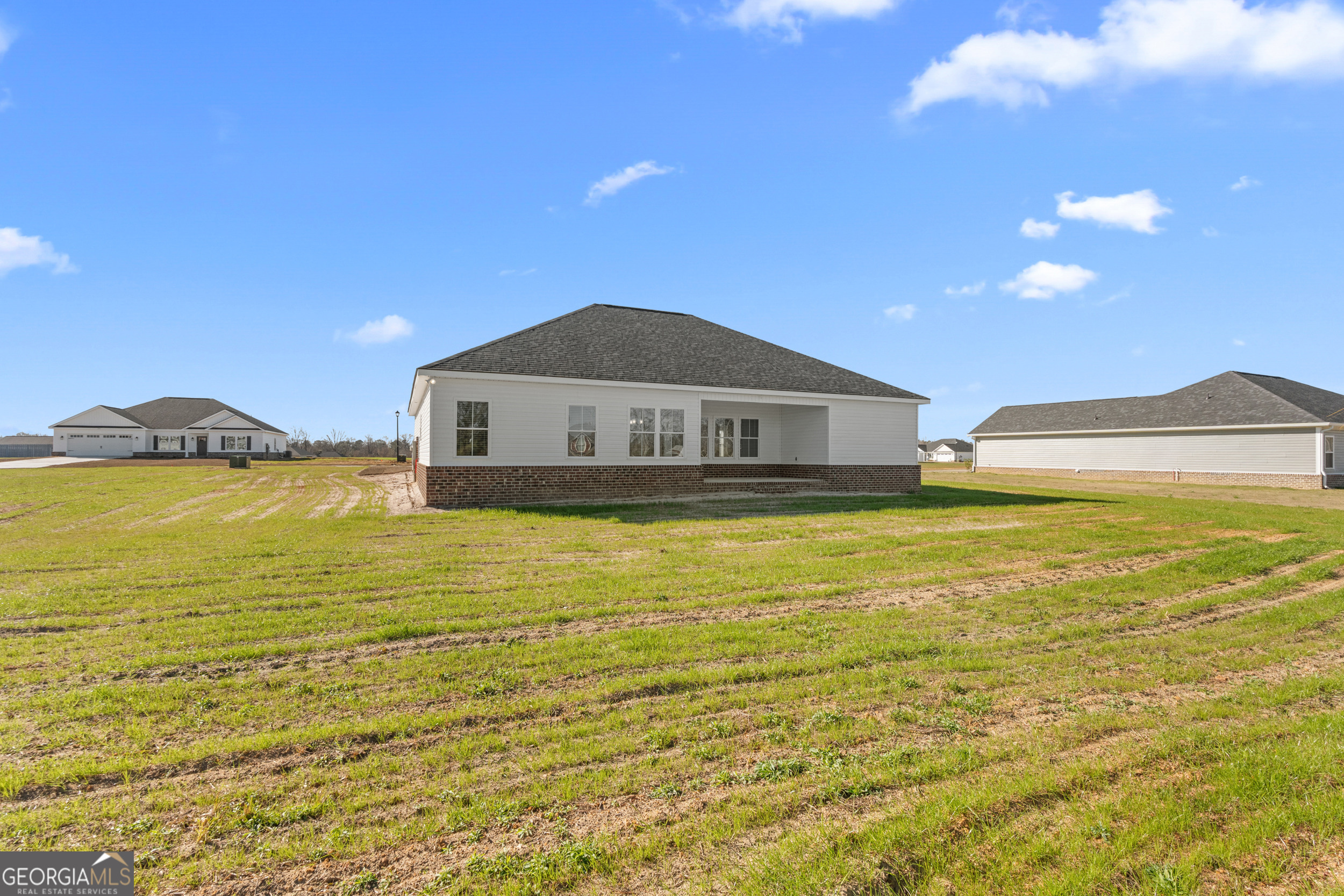 209 Hopecrest Road Statesboro, GA 30458 - Photo 22 of 27 a view of a large pool with lawn chairs under an umbrella