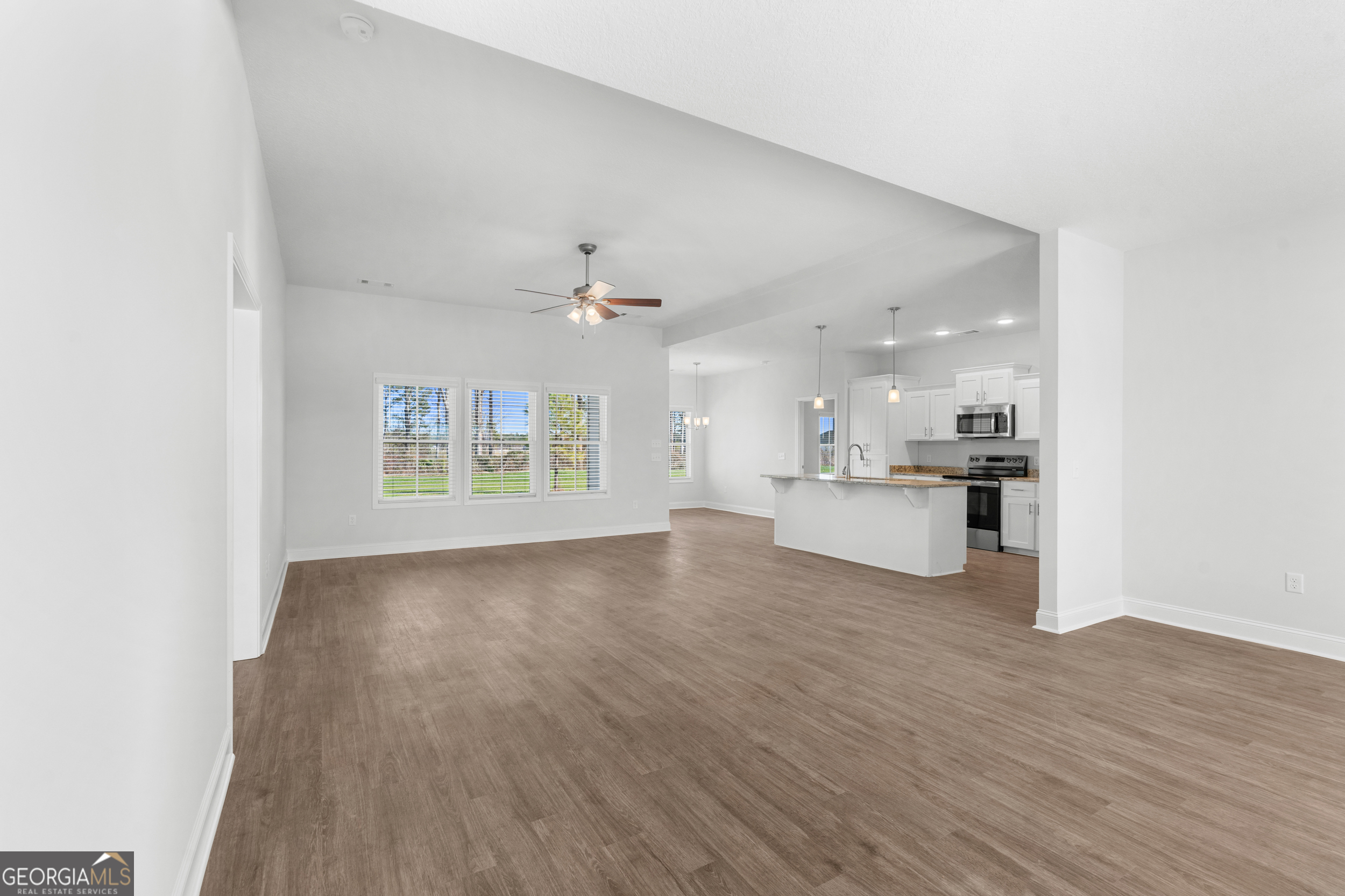 209 Hopecrest Road Statesboro, GA 30458 - Photo 6 of 27 a view of an empty room with kitchen and window