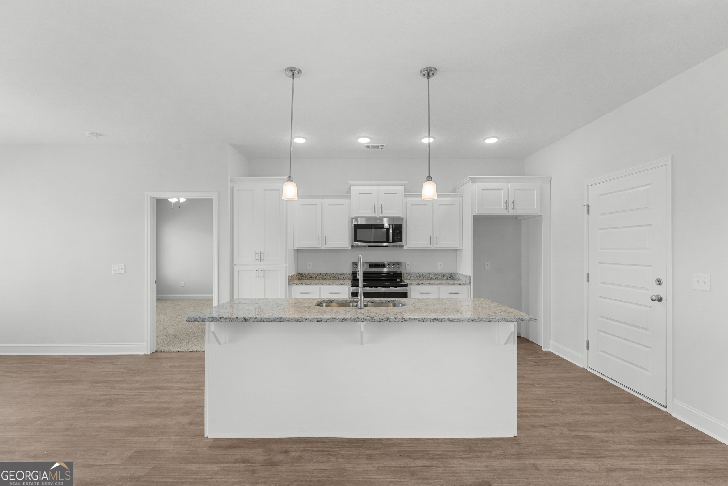 209 Hopecrest Road Statesboro, GA 30458 - Photo 8 of 27 a large kitchen with stainless steel appliances kitchen island a large island in the center