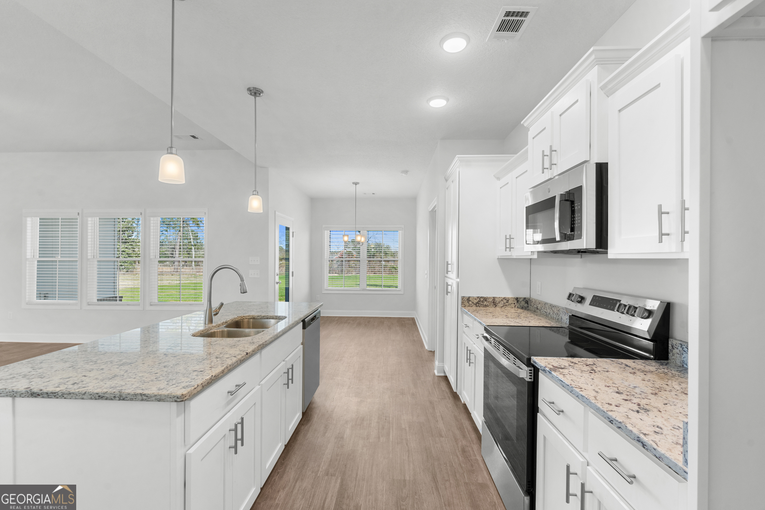 209 Hopecrest Road Statesboro, GA 30458 - Photo 9 of 27 a kitchen with granite countertop a sink stove and cabinets