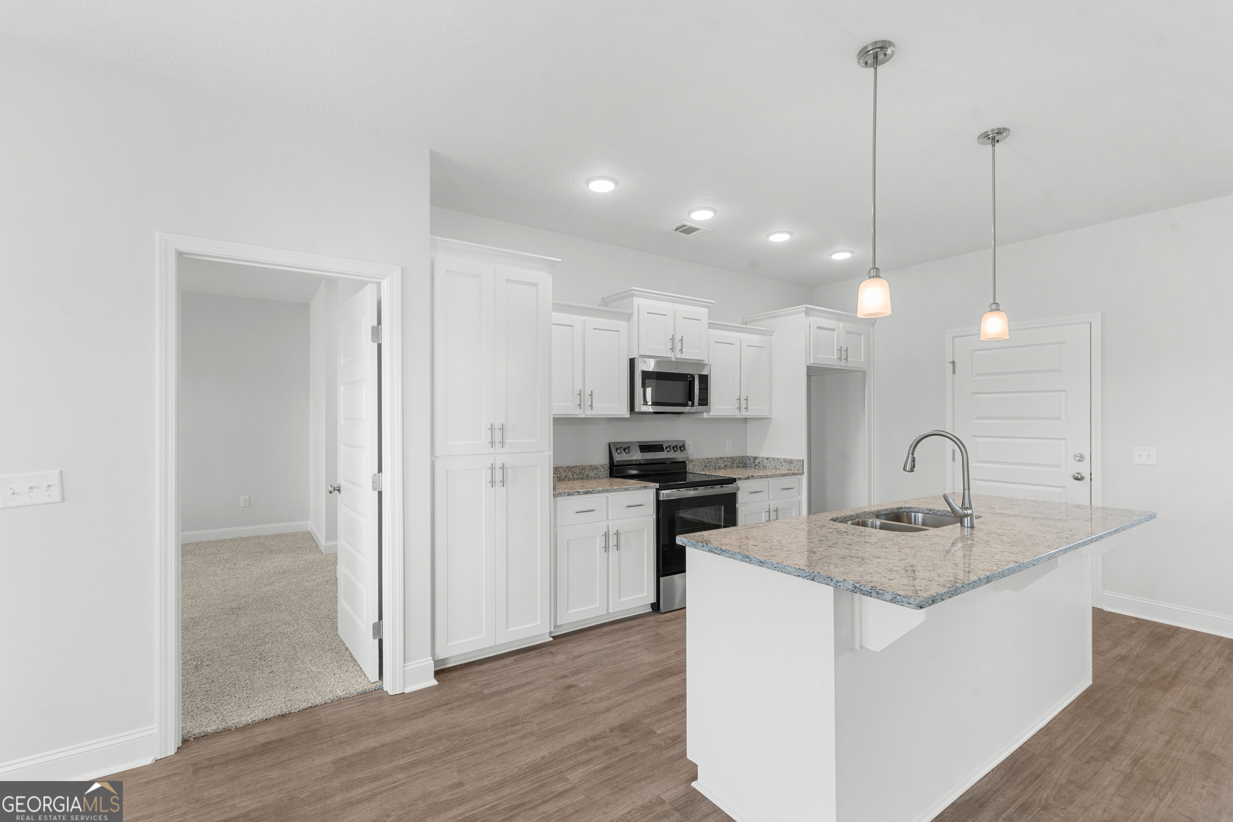 209 Hopecrest Road Statesboro, GA 30458 - Photo 10 of 27 a kitchen with stainless steel appliances granite countertop a sink a stove a refrigerator and island with wooden floor