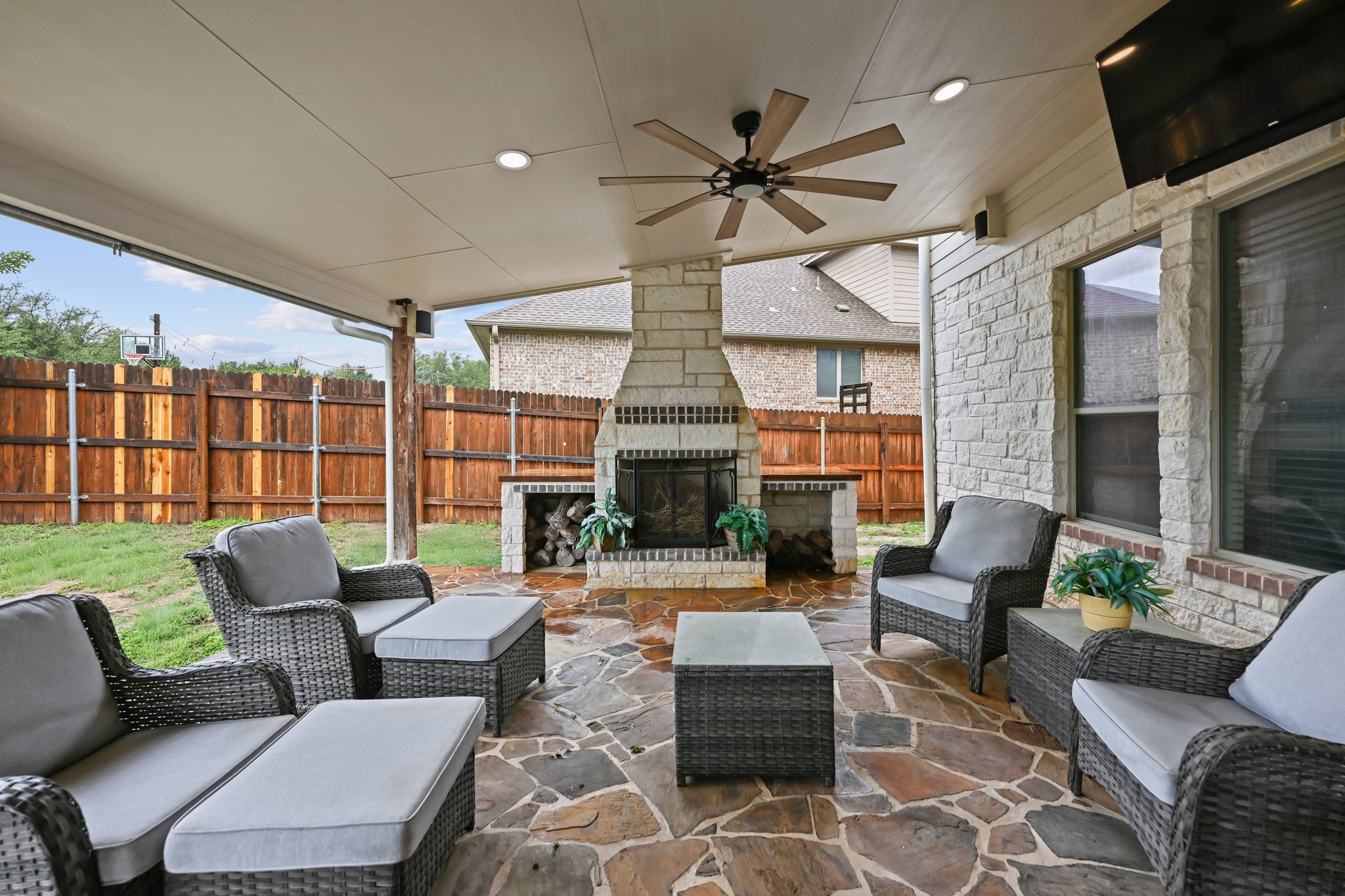 5528 Wild Foxglove Road Spicewood, TX 78669 - Photo 33 of 38 Covered patio featuring flagstone flooring and a stone fireplace