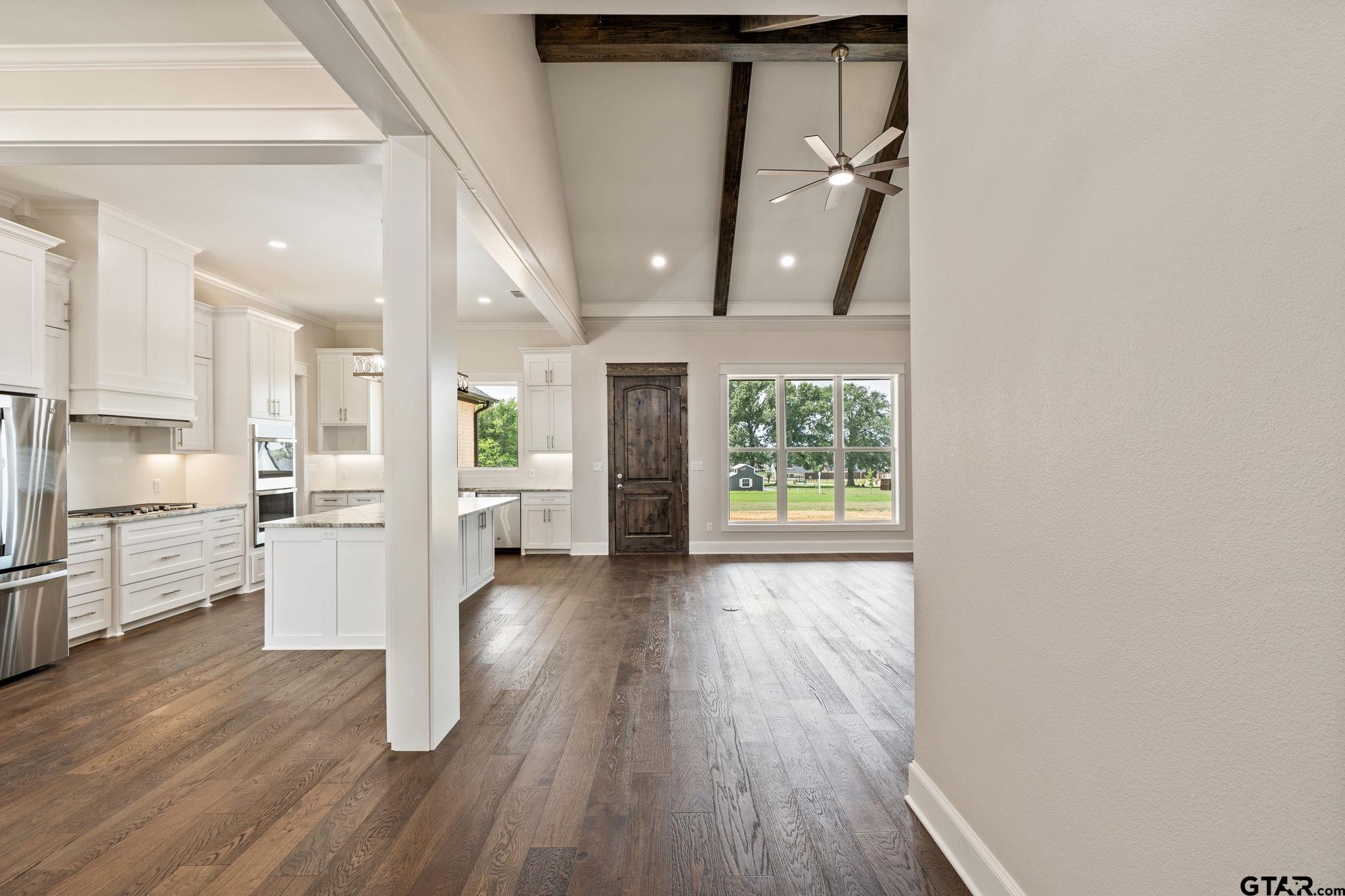 21064 Woodring Road Bullard, TX 75757 - Photo 14 of 48 a view of a living room and kitchen with furniture wooden floor and window
