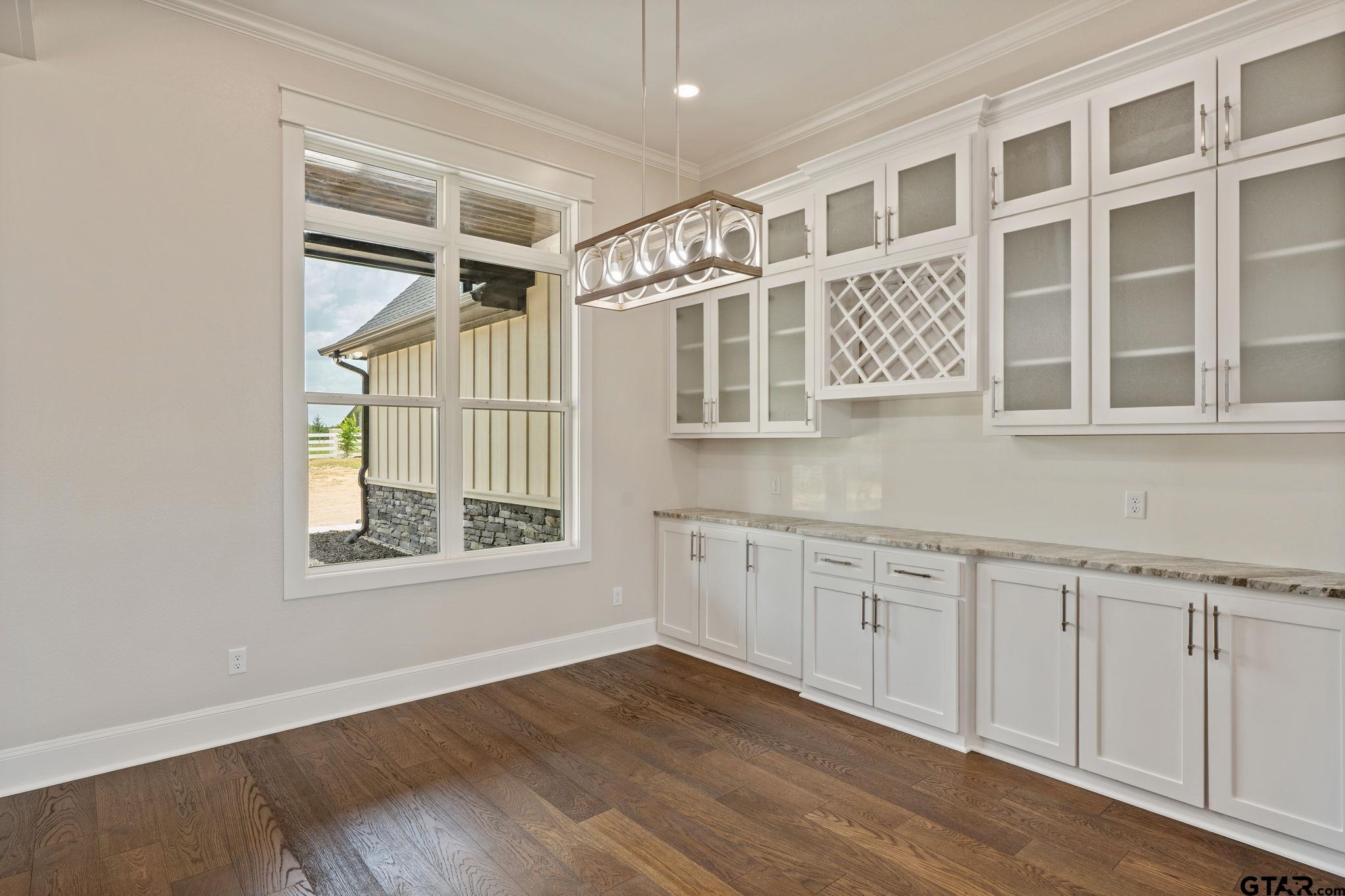 21064 Woodring Road Bullard, TX 75757 - Photo 16 of 48 a view of an empty room with a window and wooden floor