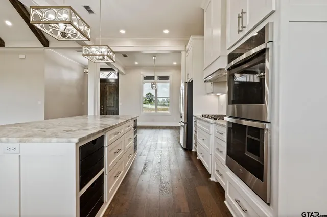 a view of kitchen and hall with wooden floor