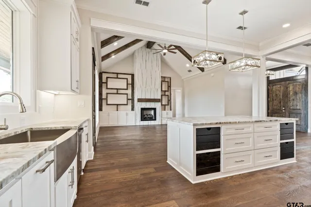 a kitchen with stainless steel appliances a chandelier counter space and wooden floor