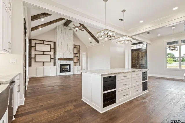a view of empty room with wooden floor and fireplace