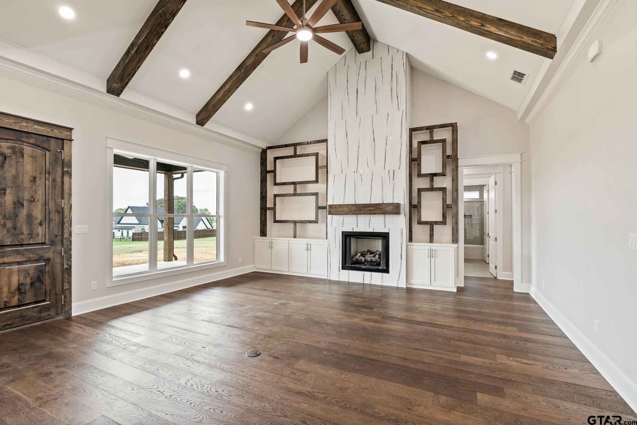21064 Woodring Road Bullard, TX 75757 - Photo 25 of 48 a view of empty room with wooden floor and fireplace