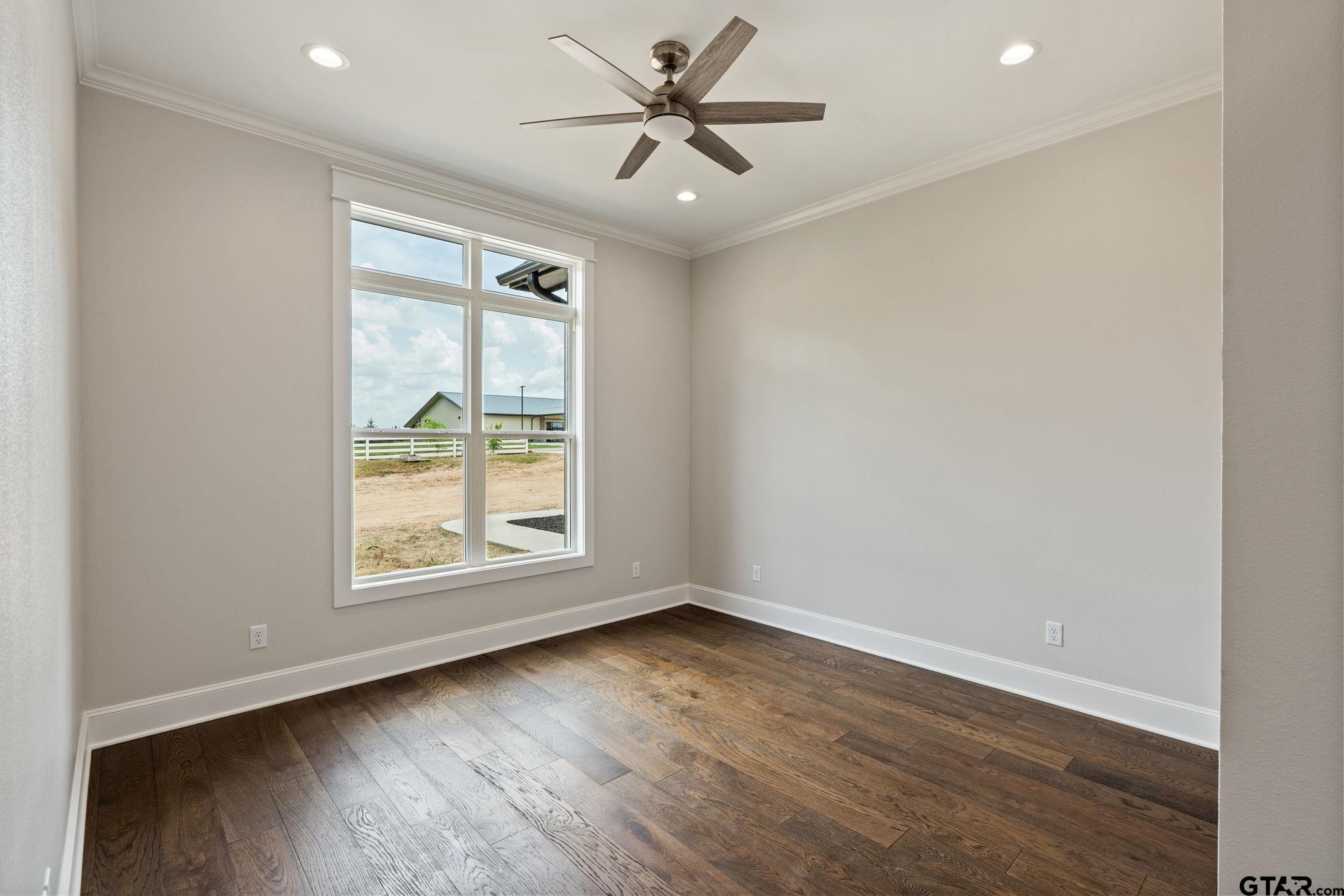 21064 Woodring Road Bullard, TX 75757 - Photo 29 of 48 an empty room with wooden floor and windows