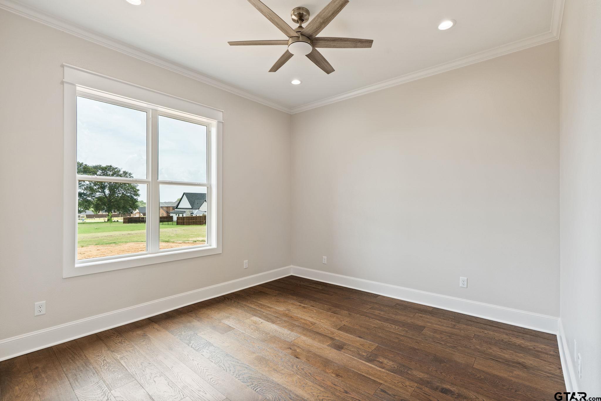 21064 Woodring Road Bullard, TX 75757 - Photo 33 of 48 an empty room with wooden floor and windows