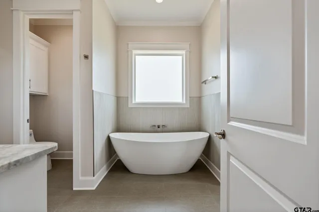 a spacious bathroom with a granite countertop sink mirror and toilet