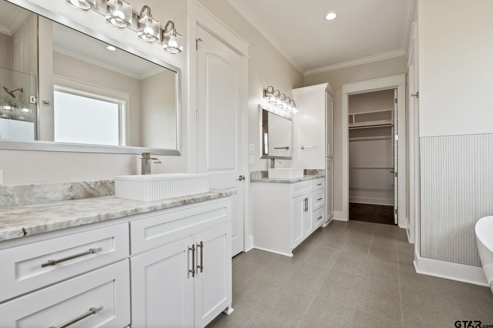 21064 Woodring Road Bullard, TX 75757 - Photo 40 of 48 a spacious bathroom with a granite countertop sink mirror and toilet